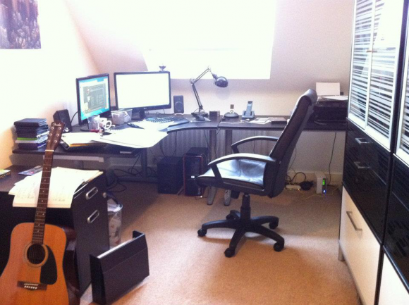 This is where the magic happens...general theme is black and white in here, maybe a need a colour to make it a little more funky? Green or something. Guitar there for a distraction. Currently learning Ed Sheeran on 